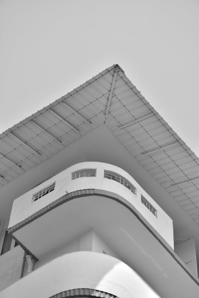 Grayscale Photo of Concrete Building with Balcony